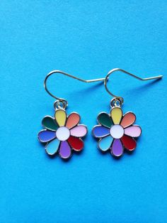 Do these multi color earrings bring a smile to your face? These  enamel rainbow/multi colored flower earrings are light weight and would match any outfit! Multicolor Enamel Jewelry With Ear Wire, Whimsical Multicolor Flower Shaped Jewelry, Cute Multicolor Jewelry With Ear Wire, Cute Multicolor Jewelry, Rainbow Colorful Earrings For Gift, Multicolor Summer Flower Charm Earrings, Summer Multicolor Flower Charm Earrings, Multicolor Flower Shaped Jewelry For Summer, Multicolor Flower-shaped Jewelry For Summer