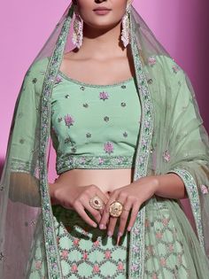 This is a 3-piece set. The set consists of short sleeves blouse with embroidery, zari work, and stonework detailing, round neck teamed with flared matching lehenga has embroidery, zari work, and stonework detailing and a net dupatta. No of piece - 3 piece Color- Pista Green Fabric-Gota Silk Blouse Sleeves-Short Sleeves Neck-Round Neck Lehenga length: Floor Length Washing instructions: Dry Clean Work-Embroidery, zari work, and stonework detailing Flared lehenga Comes with Dupatta Ships in 3-4 wee Matching Lehenga, Mehendi Lehenga, Embroidered Bridal Lehenga, Flared Lehenga, Georgette Material, Bridesmaid Lehenga, Pista Green, Georgette Lehenga, Green Thread