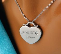 "Our silver engraved heart necklace is a great personalized gift for that special someone. Great for Bridesmaids, Flower Girls, Best Friends, or the love of your life. Engrave the heart with names, dates or a message of love. Both sides of the heart pendant can be engraved. Silver Heart Necklace Dimensions: 1.1\" X 1\" Material High Polished Silver Stainless Steel with CZ How To Send Engraving Instructions: When you are ready to order click ADD TO CART. During checkout fill out the ADD A NOTE se Heart Cut Heart Charm Necklace For Wedding, Heart Cut Necklace With Heart Charm For Wedding, Personalized Stainless Steel Heart Necklace For Anniversary, Heart Cut Heart Necklace For Mother's Day Wedding, Heart Cut Heart Necklace For Wedding On Mother's Day, Heart Cut Necklace For Wedding And Mother's Day, Heart Pendant Necklace For Valentine's Day Wedding, Heart-shaped Wedding Necklace With Engraving Option, Heart Shaped Wedding Necklace With Engraving Option