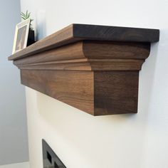 a close up of a wooden shelf on the wall