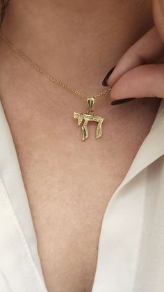 ★HEBREW CHAI GOLD NECKLACE★ My specially designed unisex CHAI gold pendant. 14K solid gold necklace. The "Chai" is a known Jewish and Hebrew word, symbol, amulet, and blessing.  The meaning it holds is 'life' and it is a symbol of good luck and a long good life. Chai Necklaces can be worn by people of all genders and ages. Mostly given as a Bar Mitzvah gift. Necklace Details: ★ Solid 14K gold, Choose your gold color yellow gold / white gold / rose gold ★ Choose the number of the style you want i Gold Charm Necklace With Polished Finish In 14k Gold, 14k Gold Polished Charm Necklaces, Gold 14k Polished Finish Charm Necklace, Polished 14k Gold Charm Necklace, 14k Yellow Gold Amulet Charm Necklaces, Yellow Gold Pendant Necklace For Good Luck, Yellow Gold Good Luck Pendant Necklace, 14k Gold Engraved Necklace For Good Luck, Good Luck Engraved 14k Gold Necklace