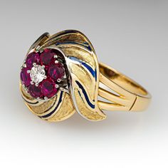 This elegant circa 1940s features engraved details with blue enameling. The ring is centered with one (1), prong set, round brilliant cut diamond, bordered with six (6), prong set, round mixed cut natural rubies. The ring measures 17.8mm at the top, rises 9.6mm above the finger, tapering to 2.3mm wide and 1.1mm thick at the base of the shank. This ring is currently a size 10. Antique Round Enamel Ring For Anniversary, Fine Jewelry Enamel Ring With 17 Jewels For Anniversary, Heirloom Enamel Ring For Formal Occasions, Heirloom Style Oval Enamel Ring For Formal Occasions, Formal Round Enamel Diamond Ring, Formal 14k Gold Enamel Ring Fine Jewelry, Antique Enamel Rings For Formal Occasions, Classic Formal Enamel Round Ring, Art Deco Enamel Rings For Formal Occasions