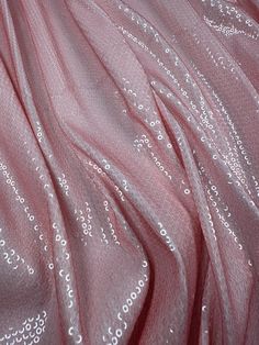 What is Sequin Fabric? ( Width: 140 cm / 1.53 yards / 55.12 inches ) Sequin fabric, also known as sequin or glitter fabric, is a type of textile adorned with small, shiny discs called sequins. These sequins are typically made from plastic, metal, or other reflective materials, and are sewn or adhered onto the fabric to create a dazzling, sparkling effect. Sequin fabric is highly favored for its glamorous appearance and is often used in fashion and design to add a touch of sparkle and luxury. Use Luxury Elegant Holiday Sequin Fabric, Clothing Texture, Pink Fabrics, Highly Favored, Types Of Textiles, Sequins Fabric, Baby Pink Aesthetic, Soft Pink Color, Reflective Material