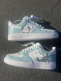 These custom Kaws-inspired Air Force 1 sneakers feature a stunning Prelude Gray and white color scheme with intricate hand-painted Kaws graphics. The iconic Companion character is showcased in detail, blending effortlessly with the swirling abstract designs and signature 'X' motifs across the shoes. Made with precision and creativity, these one-of-a-kind kicks offer a unique blend of street art and high fashion, perfect for sneakerheads and art lovers alike. Artistic Low-top Sneakers With Custom Artwork, White Sneakers With Graffiti Print For Sports, Artistic Blue Sneakers For Streetwear, Artistic Blue Sneakers With Custom Artwork, White Custom Sneakers With Graffiti Print, Hand Painted White Low-top Custom Sneakers, White Low-top Graffiti Sneakers, White Sporty Sneakers With Graffiti Print, Sporty White Sneakers With Graffiti Print