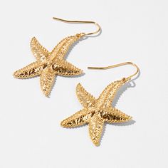 Give yourself instant island vibes with these drop earrings. These stylish gold-tone earrings have texturized starfish charms that are perfect for warm-weather fun. Finish: Gold-tone Drop: 1" Closure: Fish hook Material: Metal - Claire's Gold Starfish 1" Drop Earrings