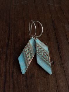 These earrings feature mixed metals of solid, gold brass & raw copper and are finished with a unique turquoise verdigris patina. The patina has been sealed with a good coating of renaissance wax but should not be worn while showering or bathing to maintain patina. The ear wires are forged by hand from 20g Sterling silver. These earrings have a celtic / tribal feel. They are versatile and suitable for just about any style, from modern to rustic. They're substantial but comfortable to wear. Th Copper Dangle Jewelry With Patina, Copper Dangle Earrings With Patina, Blue Artisan Copper Earrings, Artisan Blue Copper Earrings, Unique Blue Copper Earrings, Earthy Nickel-free Copper Jewelry, Soldered Turquoise Brass Earrings, Turquoise Soldered Brass Earrings, Bohemian Electroformed Bronze Jewelry