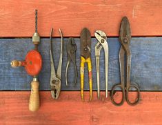 there are many different types of tools on the wooden table, including pliers and wrenches