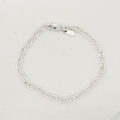 This Silver Charm Bracelet is a stylish and versatile accessory for women. Made of high-quality .925 sterling silver, this bracelet adds a touch of elegance to any outfit. With its simple yet eye-catching design, it is perfect for everyday wear or special occasions. Enhance your style with this must-have piece. The bracelet is 7" long, and charms are sold separately. Classic Silver Chain Bracelet For Everyday, Classic Everyday Silver Chain Charm Bracelet, Classic Silver Charm Bracelet For Everyday, Everyday Round Charm Bracelet Jubilee Style, Minimalist Silver Chain Bracelet With Sterling Clasp, Minimalist Chain Bracelet With Sterling Silver Clasp, Silver Minimalist Bracelet With Lobster Clasp, Minimalist Silver Bracelet With Lobster Clasp, Modern Silver Charm Bracelet For Everyday