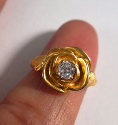 This is a beautiful hand carved 14 kt yellow gold rose ring with leaves. The center stone is a .25 ct G/H color SI1- SI2 clarity diamond. Can also be ordered in white gold, rose gold, and platinum. Comes in sizes 4.5 to 10. Delivered in a beautiful box. 100% MONEY BACK GUARANTEE Gold Rose Ring, Ring With Leaves, Bell Gardens, Rose Leaf, Rose Leaves, Ring With Diamond, Rose Ring, Leaf Ring, G H