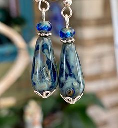 "Beautiful Czech glass dark blue teardrop with a Picasso finish make these earrings unique and a great accessory for anytime. The teardrop is 20x9mm and a 4mm dark blue bead with Picasso finish. They dangle 1 1/2\". They are on Sterling Silver Ear Wires. This Czech Glass is truly amazing the colors are so pretty. The Picasso finish on these is heavy but the blue glass shines thru they are so pretty in the light. They do look different in different light settings either low light or bright they a Artistic Nickel-free Czech Glass Earrings, Blue Recycled Glass Dangle Earrings, Blue Czech Glass Drop Earrings, Nickel-free Blue Teardrop Crystal Earrings, Conference Call, Nickel-free Lapis Lazuli Dangle Earrings, Next Video, Earrings Unique, Low Light