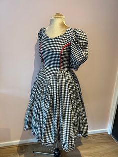 Vintage 1950's gingham dress, 50's handmade gingham dress, 50s swing dress with puff sleeves. UK 6 - 8 A vintage 1950's handmade gingham dress with puff sleeves. It has a metal zip down the centre back. There is no fabric label but it feels like cotton or a polycotton. Wear with a underskirt (not included) for that 50's full skirt look. It will fit a size 6 - 8, but please check measurements. The waist and hips are generous but the chest is measuring a size 6, so check your chest measurement. UK Retro Plaid Dresses For Vintage Fashion, Fitted Retro Vintage Dress For Picnic, Fitted Retro Plaid Vintage Dress, Fitted Plaid Retro Vintage Dress, Retro Plaid Fitted Vintage Dress, Retro Plaid Dress For Picnic, Fitted Gingham Retro Vintage Dress, Fitted Vintage Gingham Dress In Retro Style, Fitted Gingham Vintage Dress