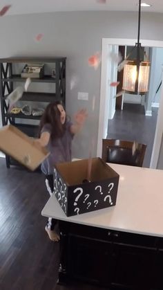 a girl is playing with a box on the floor