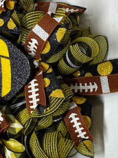 a bunch of football themed hair ties on top of each other