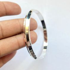 Name Of Product:- 925 Sterling Silver Kada Material: Silver Size & Weight: 2.2 - 21 grams 2.4 - 22.50 grams 2.6 - 23.50 grams To measure the size of the bangle: Hold your hand as if you were putting on a kada. Bring all of your fingers together with your thumb and little finger touching. Measure around the hand at the widest point with a tape measure or a strip of paper. Be sure to pull the paper or tape measure snug against your skin. Mark the paper with a pen and measure it with a ruler. T Silver Bangle With Sterling Silver Clasp, Silver Sterling Bangle, Silver Bangle Stamped 925, Silver Sterling Silver Bangle, Silver Sterling Silver Bracelets With Shiny Finish, Sterling Silver Bangle With Shiny Finish For Anniversary, Silver Sterling Silver Bracelet With Shiny Finish, Sterling Silver Bracelets With Shiny Finish, White Gold Sterling Silver Bangle Stamped 925