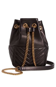 Lightly grained lambskin is juxtaposed against quilted pockets on this scaled-down bucket bag with an adjustable chain strap that cinches the top. Drawstring closure Chain strap Exterior pockets Lined Leather Made in Italy Designer Handbags Luxury Chic Bucket Bag With Chain Strap, Chic Bucket Bag With Chain Strap, Bucket Bags, Black Bucket Bag With Chain Strap, Black Luxury Bucket Bag With Chain Strap, Luxury Black Bucket Bag With Gold-tone Hardware, Leather Bucket, Mens Eyewear, Platform Slippers