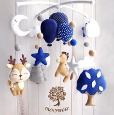 a mobile with several stuffed animals hanging from it's sides and stars on them