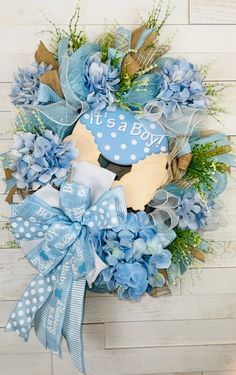 a blue and white wreath with it's a boy sign