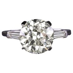 an old mine cut diamond ring with baguets on the sides and three prongs