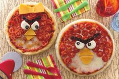 two pizzas decorated to look like angry birds with tomatoes and cheese on the top