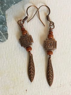 the earrings are made with metal and wood