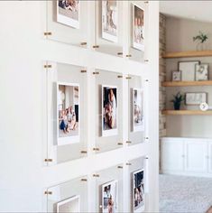 a wall with many pictures hanging on it