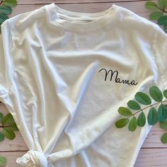 Share your greatest achievement with an everyday white tee dedicated to being a mama. This white T is the perfect shirt for running errands, hanging with your little ones, or celebrating being a mom with your mom squad. T-shirts are unisex sizing. Recommended washing instructions: Wash and dry garments inside out Wash with cold or warm water Use a mild detergent Tumble dry low or hang dry Do not iron directly on the design White Relaxed Fit T-shirt For Family Matching, White T-shirt With Letter Print For Mother's Day, White T-shirt For Mother's Day Gift, White Letter Print T-shirt As Gift, Mother's Day Graphic Tee With Name Print, White Graphic Tee With Name Print, Mother's Day Name Print Graphic Tee, White Custom Text Tops For Family Matching, Mother's Day Letter Print T-shirt