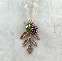 "Detailed woodland style necklace with antiqued brass leaf, copper pine cone and Swarovski briolette all are charmed together and make a beautiful delicate necklace. Perfect for everyday or that special occasion. Great layered or alone. Please be sure to select a chain length and crystal color. Chain is an antiqued gold patina. Antiqued brass lobster clasp. Leaf measures 37mm and Briolette is 11mm. Vintage inspired jewelry by Lauren Blythe Designs. DETAILS Please choose your briolette color as s Pine Cone Necklace, Pine Cone Jewelry, Pinecone Necklace, Winter Necklace, Pinecone Pendant, Necklace Leaf, Rustic Necklace, Woodland Jewelry, Vintage Inspired Jewelry