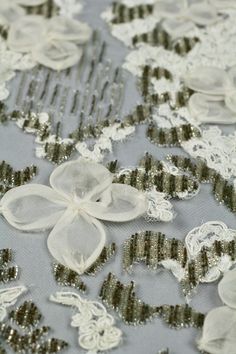 white and black lace with flowers on grey background, closeup shot in full frame