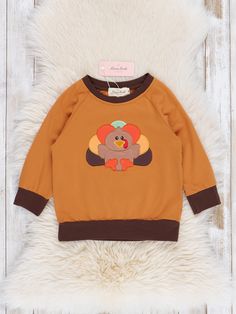 This playful top is perfect for your little turkey! Featuring an embroidered turkey and deep brown trim, it's a stylish choice for any occasion. Plus, it's part of our sibling set collection for a fun matching look. Gobble it up before it's gone! Fits true to size. 97% Cotton / 3% Spandex Combo: 95% Polyester / 5% Spandex Import. *Afterpay and Sezzle Purchase Requires $35 Minimum Order. Turkey Shirts, Brown Trim, Deep Brown, Orange Brown, Trim, Spandex, Orange