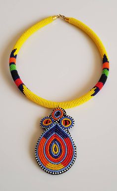 "100% handmade using fine beads. Dimensions: 6\" diameter , 3\" pendant. Primary color:Yellow **This necklace ships worldwide via Dhl express. **Buy multiple items and pay shipping for one item Only. More neckleces here; https://www.etsy.com/shop/TribalTess?ref=seller-platform-mcnav&section_id=21306083 Back to my shop; https://www.etsy.com/shop/TribalTess?ref=seller-platform-mcnav" Handmade Unique Pendant Beads, Handmade Orange Beaded Pendant Necklace, Orange Beaded Dangle Necklaces, Unique Orange Beaded Necklace With Colorful Beads, Yellow Dangle Necklaces As Gifts, Unique Orange Beaded Necklace, Traditional Yellow Beaded Necklaces With Polished Beads, Beaded Pendant Necklace For Festivals, Pendant Beaded Necklace With Polished Beads For Festivals