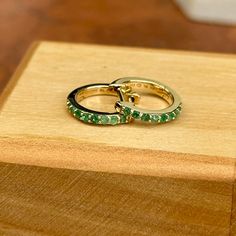 10KT yellow gold genuine emerald huggie hoop earrings. Emerald is the birthstone for May Babies! Length: 8mm Diameter: 8mm Thickness: 1.5mm Weight: 1.03 grams Stamped 10K 10K solid gold Latch backs One pair (16) 1.5mm genuine, prong set, round emeralds Can also do in ruby Earrings Emerald, White Gold Bracelet, Rose Gold Pendant, Back Jewelry, White Gold Necklaces, White Gold Earrings, Rose Gold Bracelet, Yellow Gold Bracelet, Huggie Hoop Earrings