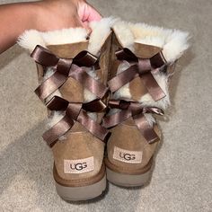 Brand: Ugg Style: Bailey Now Color: Chestnut Condition: Worn Once / Perfect Condition New Uggs 2024, Uggs Bow Boots, Ugg Boots Aesthetic, Aesthetic Uggs, Space Shoes, Juicy Couture Boots, Bow Uggs, Cute Uggs, Groovy Clothes