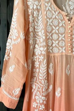 This Muslin Silk Handcrafted Lucknowi Chikankari A Line Kurta Dress in Peach is a beautiful and stylish choice for any woman. Crafted from soft muslin silk, this A line dress offers a comfortable and relaxed silhouette. The fabric is skin friendly and features heavy Lucknowi chikankari embroidery thread handwork all over. Length 46" inches Long sleeves 18" inches Round neck Muslin silk A line Hand embroidered Chikankari embroidery Margin: no Dry clean Disclaimer: Since the product is hand embroi Cream Bohemian Kurta With Chikankari Embroidery, Festive Peach Dress With Floral Embroidery, Festive Peach Floral Embroidered Dress, Bohemian Beige Kurta With Chikankari Embroidery, Embroidered Peach Anarkali Dress, Traditional Peach Dress With Resham Embroidery, Elegant Peach Kurta With Chikankari Embroidery, Summer Anarkali Kurta With Cutwork, Spring Straight Kurta With Lace Work