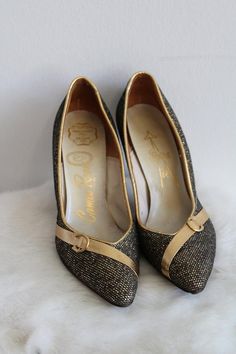 This is a vintage pair of high heel shoes. They are a deep gold/bronze tone in a metallic pattern. They also have a gold/bronze tone detail along the toe. The shoes are in good condition.Size: 5.5 NarrowInside Length: 9" | Inside Width: 3" | Outside Heel Length: 3.5" | Inside Heel Length: 2.5"Unless otherwise stated all vintage items are used and may have minor to moderate wear or discoloration considering the age of the item. Most items have been hand washed, spot cleaned, or professionally dry Gold Heels With Metal Feet For Evening, Gold High Heel Court Shoes With 4-inch Heel, Gold Court Shoes With 4-inch Heel And Almond Toe, Gold Closed Toe Heels With Metal Feet, Chic Gold Low Heel Court Shoes, Chic Gold Court Shoes With Low Heel, Gold Heels With Metallic Accents For Party, Gold Court Shoes With 4-inch Heel For Evening, Vintage High Heel Court Shoes For Party