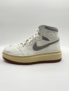 Elevate your sneaker game with these Nike Women's Air Jordan 1 SE Lifestyle shoes. The high-top, white leather design with gray accents is perfect for any athletic or casual occasion. The unique DZ3744-100 style code adds a touch of exclusivity to your wardrobe. With a size 8.5, these sneakers are perfect for any woman looking to add a stylish touch to her outfit. The Air Jordan 1 model is a timeless classic, and the Nike brand ensures top-notch quality. Don't miss out on the chance to own these Nike Urban High-top Sneakers With Contrast Sole, Mid-top Leather Jordan Shoes With Perforations, Gray Sporty Basketball Shoes With Contrast Sole, Sporty Gray Basketball Shoes With Contrast Sole, High-top Jordan Shoes With Contrast Sole, Sporty Gray High-top Sneakers With Contrast Sole, High-top Jordan Shoes With Perforations And White Sole, Leather Jordan Shoes With Perforations For Streetwear, White Basketball Shoes With Contrast Sole For Streetwear