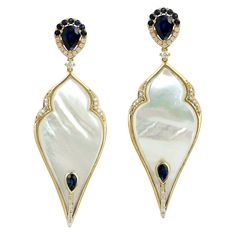 If you're looking for a beautiful pair of earrings that combines the timeless elegance of pearls with the brilliance of sapphires and diamonds, these drop shape pearl dangle earrings made in 18k yellow gold are a perfect choice. "18KT:15.095g, Diamond:0.43ct, MOP:23.70ct, SAPPHIRE:2.75ct, Size: 59X21" Luxury Yellow Gold Pearl Drop Jewelry, Luxury Blue Pearl Drop Jewelry, Luxury Yellow Pearl Drop Jewelry, Luxury Sapphire Drop Earrings, Luxury Gold-plated Pearl Drop Danglers, Premium Jewelry, Pearl Dangle Earrings, Pearl Earrings Dangle, Natural Sapphire