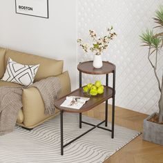 a living room with a couch, coffee table and potted plant in the corner