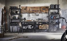 a bike parked next to a shelf filled with pots and pans