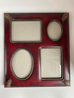 a red and silver frame with three oval mirrors