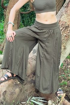 Long flowy Persephone Palazzo Pants come in one size, fits sizes 0-14. Soft stretchy viscose waist band can be worn high or folded over. Pull string around hips created snug fit for smaller body sizes. Available in Onyx, Sage and Rust. Ethically handmade of tree pulp eco Lyocell fabric its silky, luxurious and stunning, also known as vegan silk. Matching Bell Sleeve Lily Tops, Halter Tops, and Tube Tops make gorgeous eco outfits. Mix and match styles and colors. Lyocell Fabric, Tube Tops, Large Clothes, Flowy Pants, Halter Tops, Swaggy Outfits, Street Outfit, Matching Top, Palazzo Pants