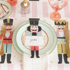 a place setting with nutcrackers, plates and utensils on it