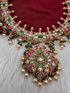 Jadau Kundan Multi Color Neckline Necklace with Emerald Beads with matching JhumkasColor : GoldenSize : Necklae Length : 14 Inches; No EarringsStones : Jadau Kundan Red Green Clear Jadau Kundan Emerald Beads Luxury Multicolor Kundan Necklace With Gemstones, Multi Color Kundan Necklace, Luxury American Diamond Kundan Necklace For Diwali, Luxury Emerald Kundan Necklace With Gemstones, Luxury Gold Kundan Necklace With Gemstone Beads, Luxury Kundan Emerald Gemstone Necklace, Luxury Heavy Kundan Chandbalis, Luxury Multicolor Kundan Temple Necklace, Luxury Beaded Kundan Temple Necklace