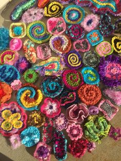 colorful crocheted items laid out on the ground