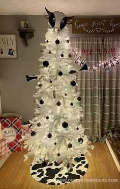 a white christmas tree decorated with black and white ornaments