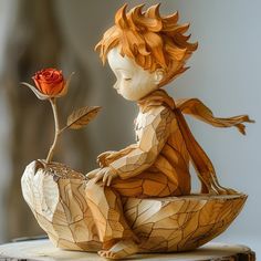 a wooden sculpture of a boy sitting on a bowl with a rose in his hand