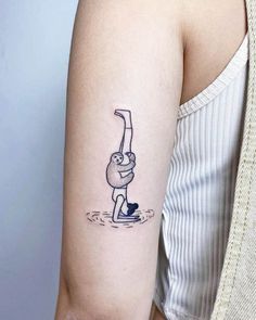 a woman's arm with a tattoo on it that has a drawing of a man holding