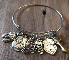 The Armor of God Bangle Charm Bracelet is made using a stainless steel bangle bracelet. It is non-tarnishing and hypo-allergenic. The charms are an antique silver color coated metal. It features the charms: Helmet of Salvation, Breastplate of Righteousness, Belt of Truth, Shoes of Peace, Shield of Faith and Sword of the Spirit. - It is a standard size and is slightly adjustable for ease in putting it on and taking it off. - It comes with a bookmark to use as a guide while praying through the Arm Silver Nickel-free Bangle For Friendship, Nickel Free Stainless Steel Jewelry For Friendship, Stainless Steel Charm Bracelet Bangle, Stainless Steel Bangle Charm Bracelet, Nickel-free Stainless Steel Bangle, Adjustable Stainless Steel Charm Bracelets, Adjustable Stainless Steel Bracelets With Charms, Nickel-free Metal Bangle Charm Bracelet, Spiritual Nickel-free Bangle Charm Bracelet