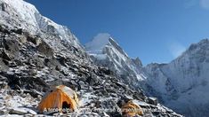 two tents pitched up on the side of a mountain