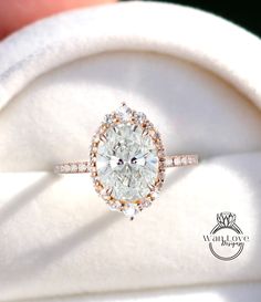 a close up of a ring with a diamond in it's center and on top of a white cloth