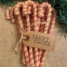 candy canes are wrapped in burlock and tied with twine for decoration